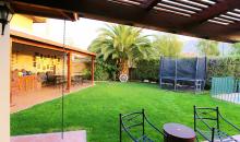 Jardín formado con árboles grandes y riego automático 